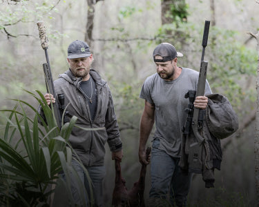 Two Hunters walking in the woods